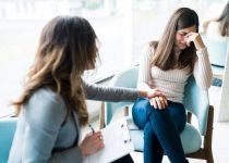 Counselor Consoling Sad Patient In Office During Session