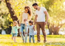 Young happy family taking a walk in the park.